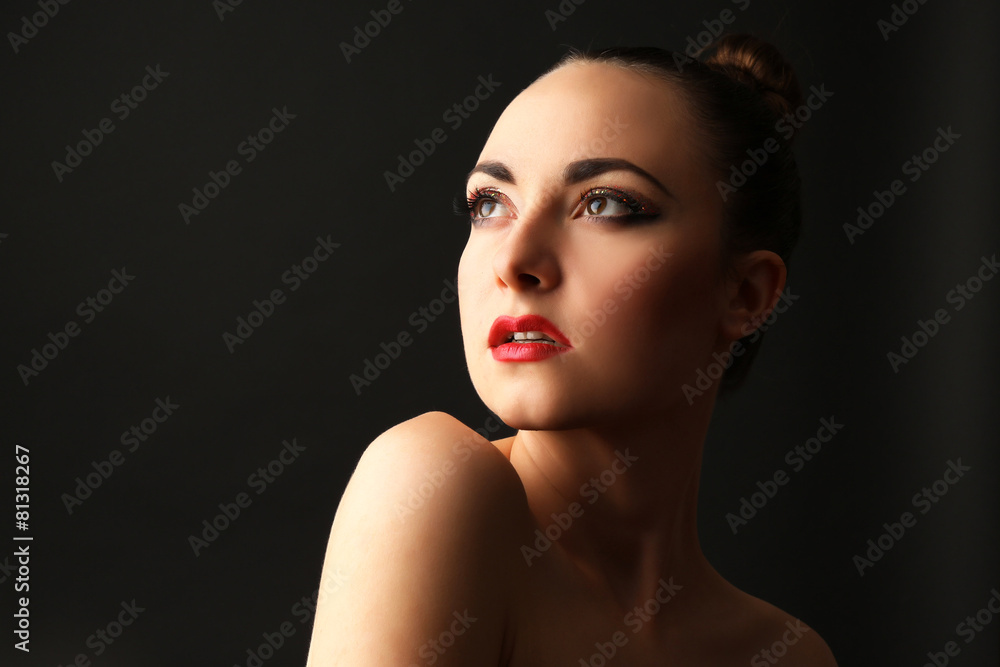 Portrait of beautiful woman with fancy glitter makeup on dark background Portrait of beautiful woman with fancy glitter makeup on dark background
