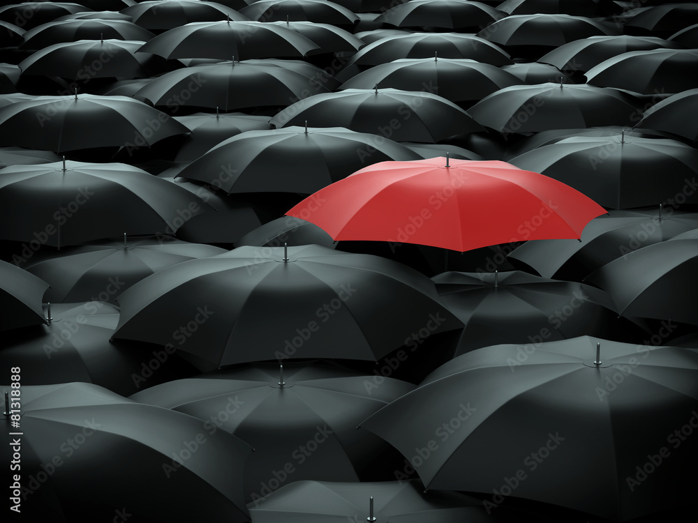 Red umbrella over many black umbrellas