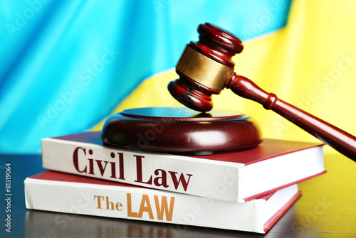 Wooden gavel and flag of Ukraine as background