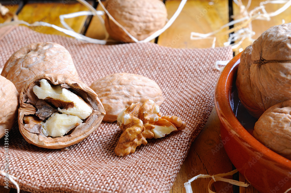 Fototapeta premium Group of healthy walnuts on a wooden table
