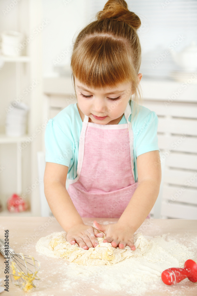 Little girl preparing cookies in kitchen at home Little girl preparing cookies in kitchen at home