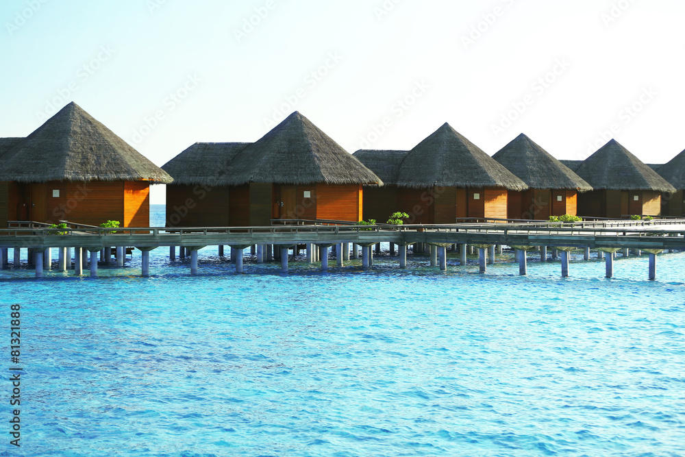 Water villas over ocean background, in resort