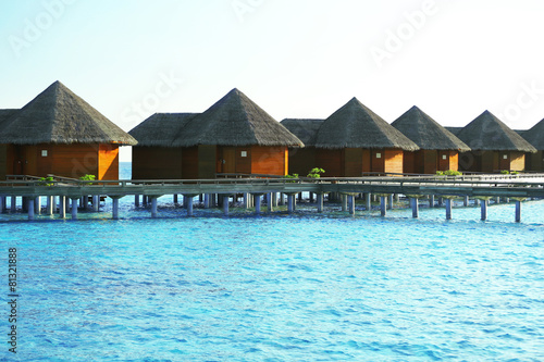 Water villas over ocean background, in resort