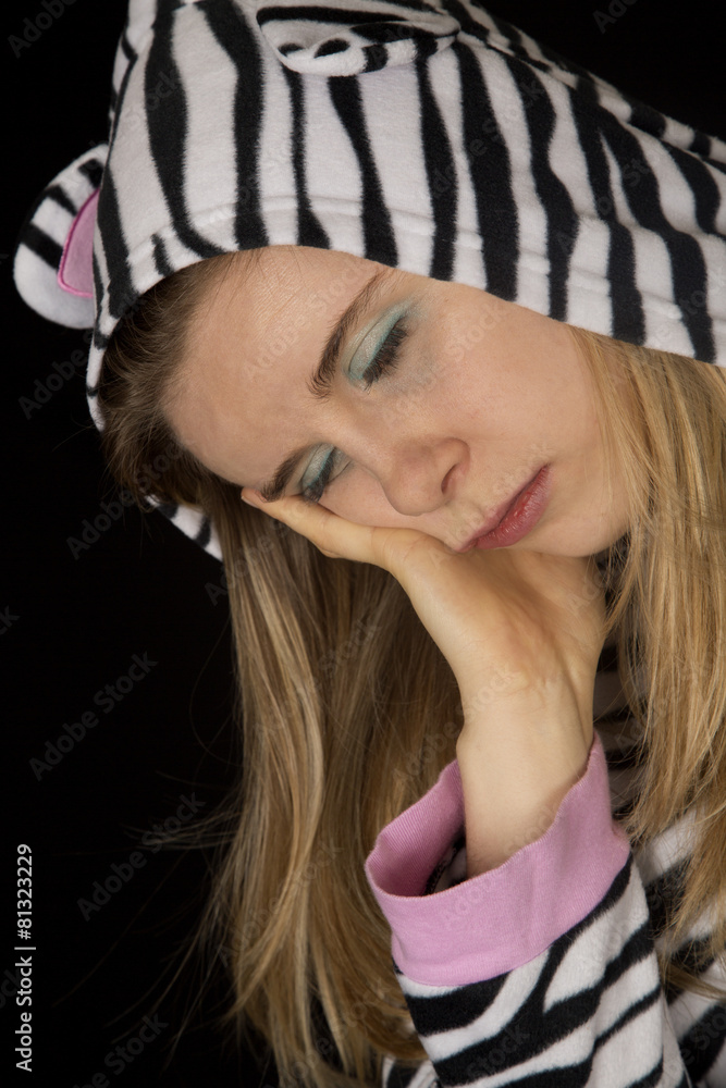 Fototapeta premium Portrait of a woman sleeping wearing cat pajamas
