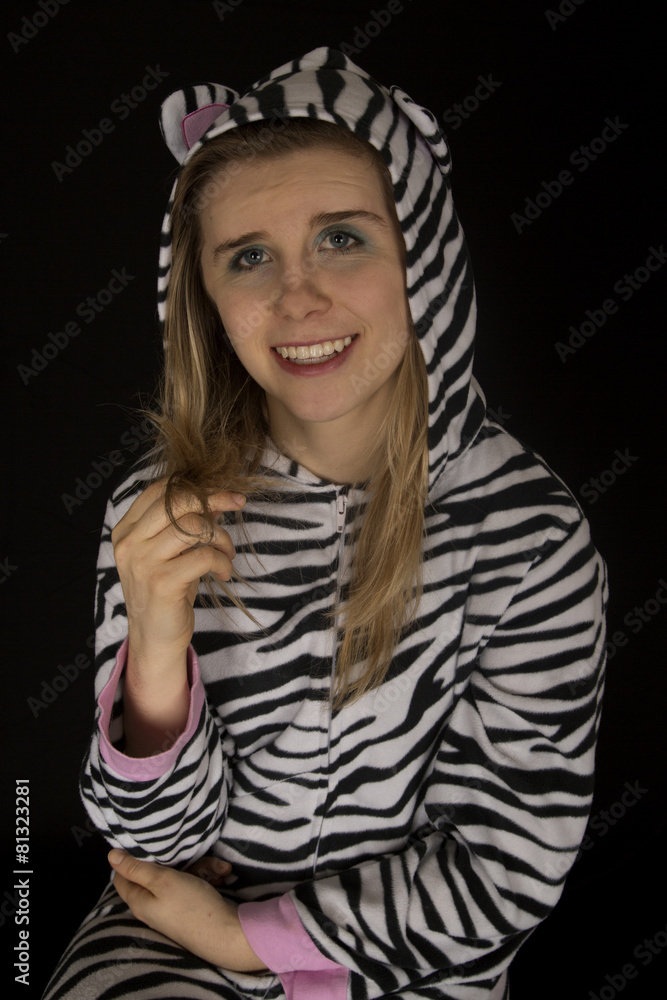 Young woman wearing cat pajamas playing with her hair Young woman wearing cat pajamas playing with her hair
