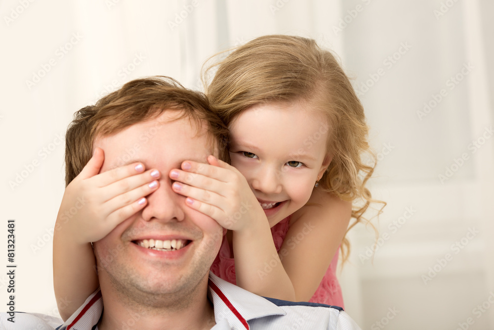 Daughter playing with father closing his eyes Daughter playing with father closing his eyes