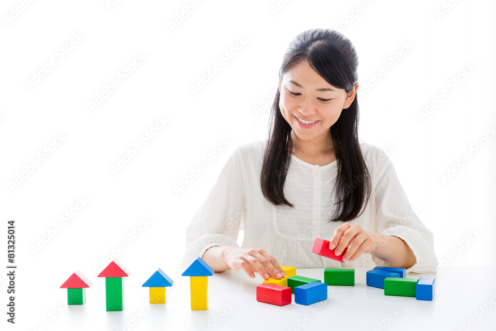 young asian woman playing building block young asian woman playing building block