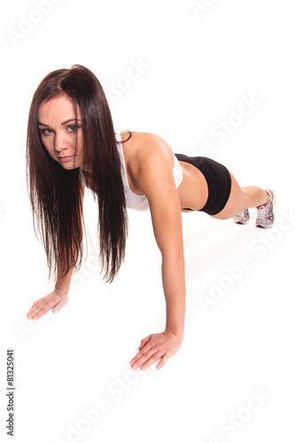 Beautiful young woman exercising in a fitness center - Pushup