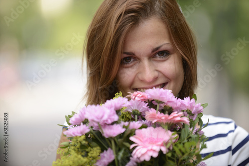 Happy woman holding floral arrangement