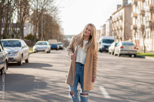 Adorable blonde girl walking alone on the road © photoguns