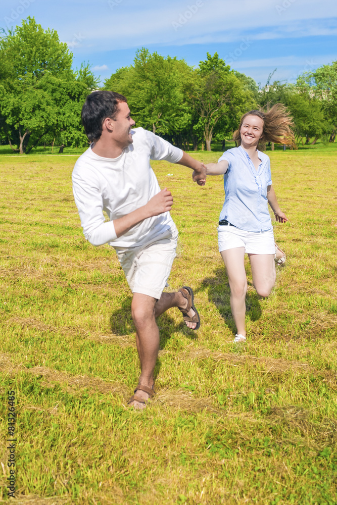 Fototapeta premium Smiling Caucasian Couple Relaxing Outdoors and Having Fun Togeth