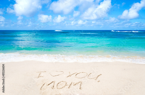 Sign "I love you mom" on the beach