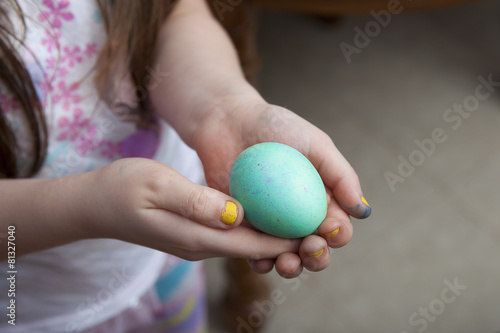 Girl With Yellow Nails Holding Blue Easter Egg