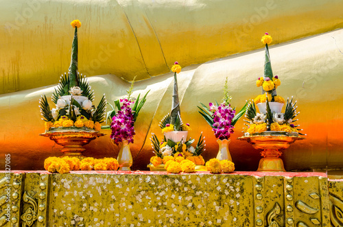 The yellow flower garlands on tray with pedestal in thai temple,