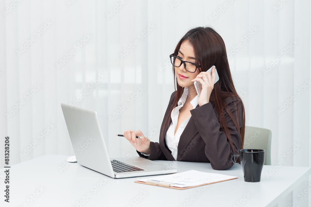 Business woman working on laptop computer at office Business woman working on laptop computer at office