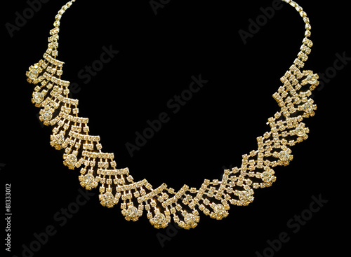 Gold and diamond necklaces isolated on black background.