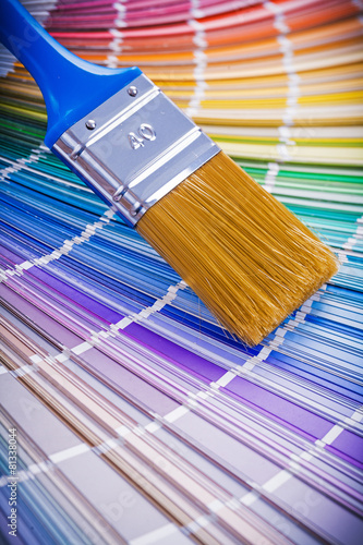 single paint brush on color palette