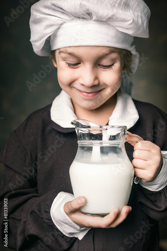 kid drinks a glass of milk