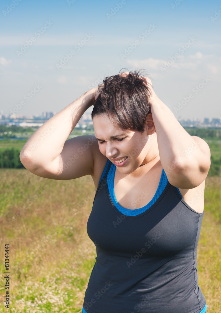 Fitness beautiful plus size woman with pain in her head Fitness beautiful plus size woman with pain in her head