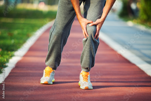 Man having pain in leg while jogging