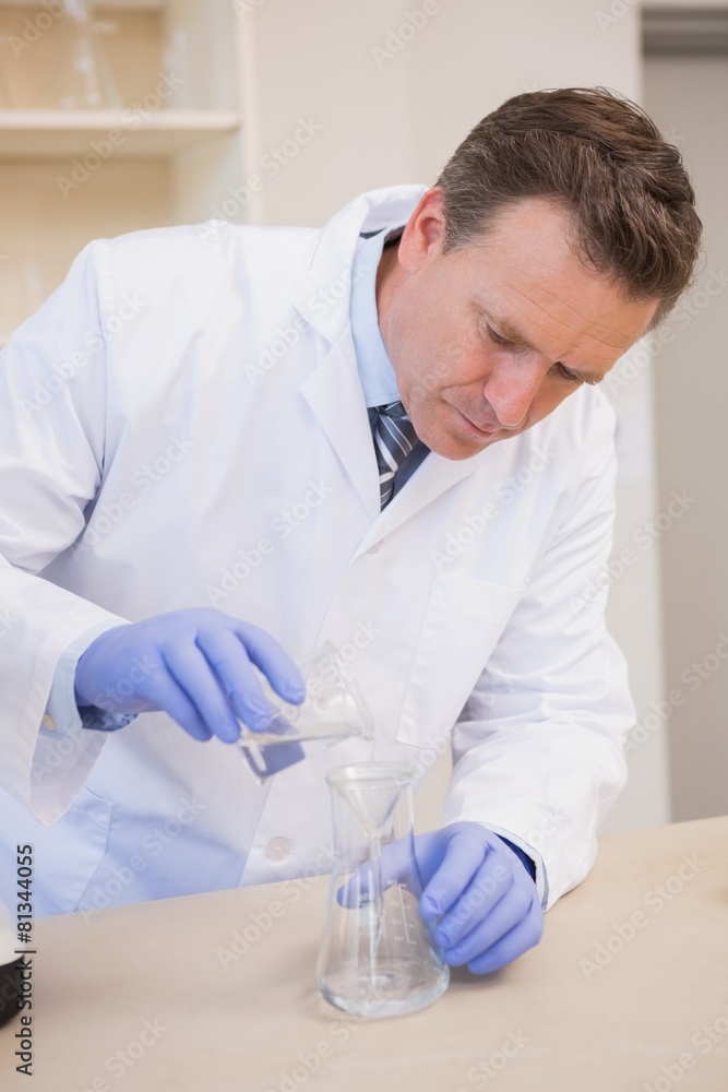 Scientist doing experimentations in flask Scientist doing experimentations in flask