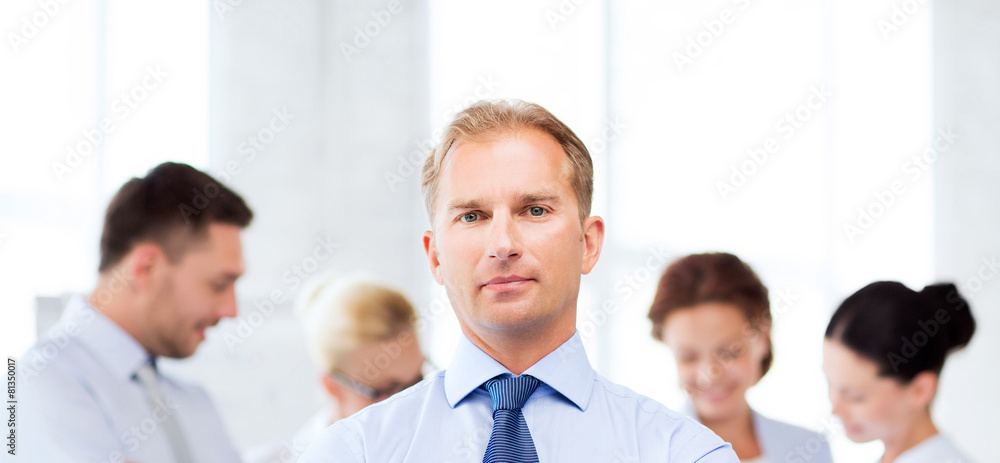 Fototapeta premium handsome businessman with team in office