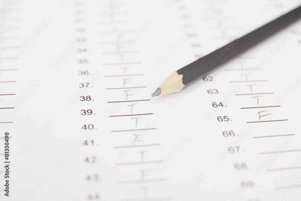 Standardized test form with answers bubbled in and a pencil, foc Standardized test form with answers bubbled in and a pencil, foc