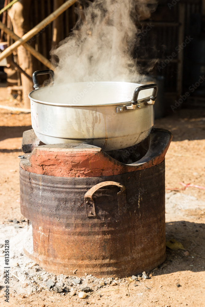 boiling water in traditional pot on charcoal stove boiling water in traditional pot on charcoal stove