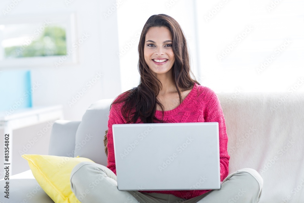 Smiling beautiful brunette doing online shopping Smiling beautiful brunette doing online shopping