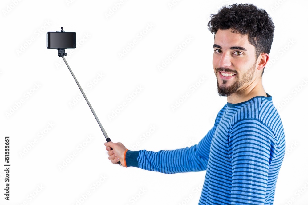 Casual man using a selfie stick Casual man using a selfie stick