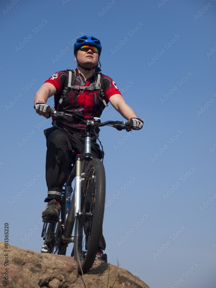 A man rides a Bicycle.
