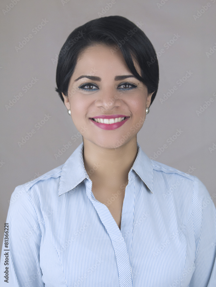 Business latin woman smiling isolated on a gray background Business latin woman smiling isolated on a gray background