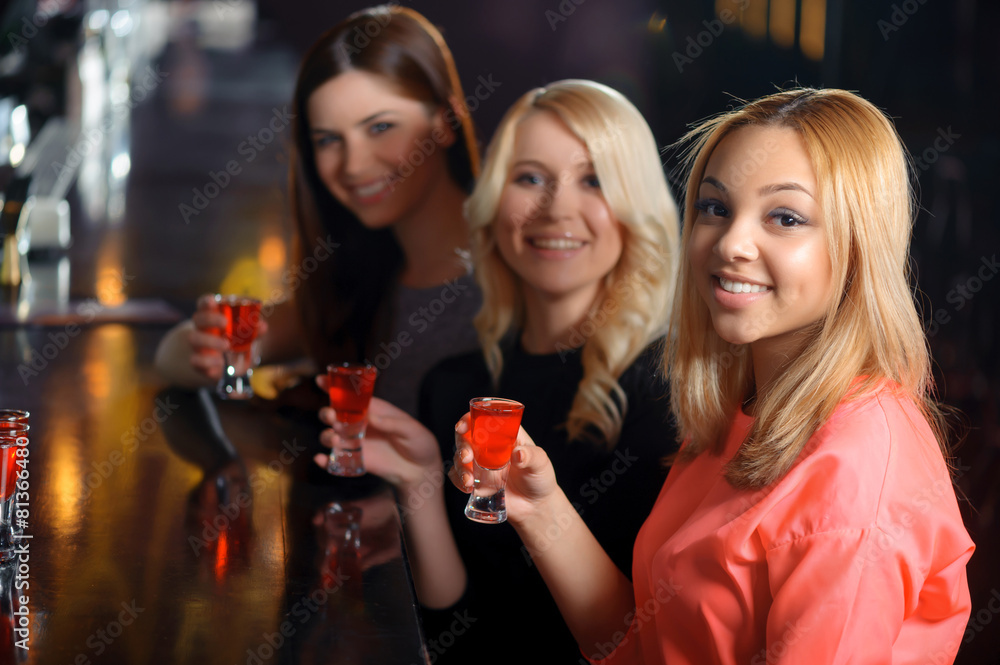 Three women have a drink in the bar