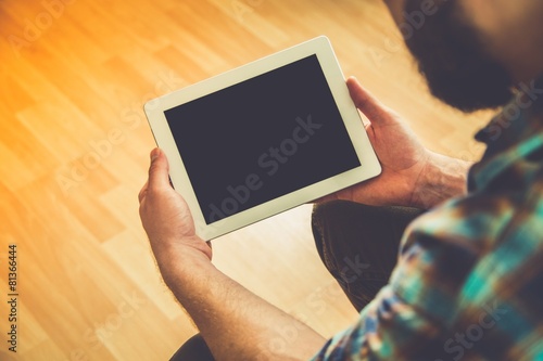Ipad. Close up to view young man's hands hold tablet with photo