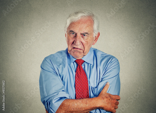 Angry grumpy pissed off senior mature man gray background  photo
