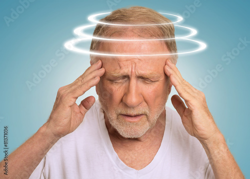 Headshot senior man with vertigo suffering from dizziness photo