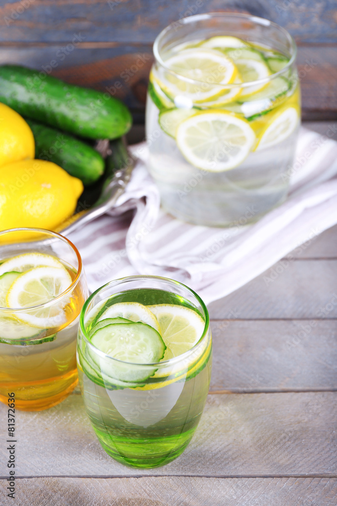 Fresh water with lemon and cucumber in glassware Fresh water with lemon and cucumber in glassware