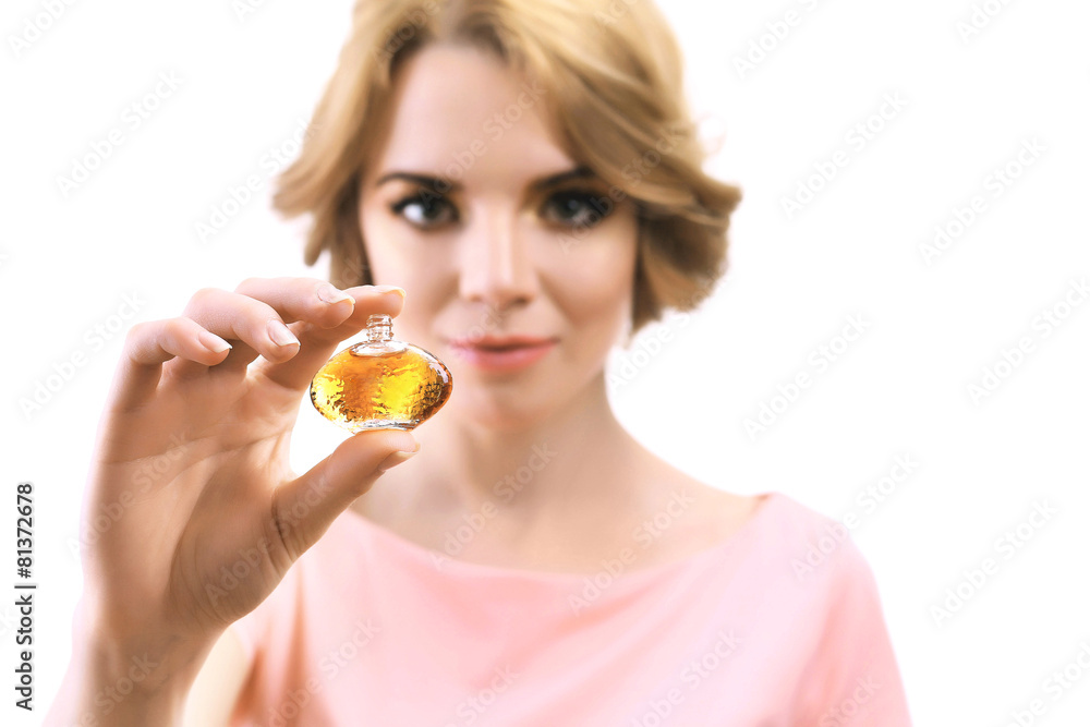 Beautiful young woman with perfume bottle isolate on white Beautiful young woman with perfume bottle isolate on white