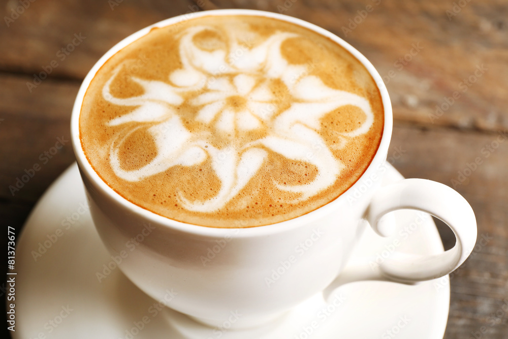 Cup of coffee latte art on wooden table, closeup Cup of coffee latte art on wooden table, closeup