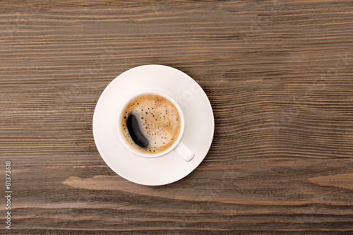 Cup of coffee on wooden table  top view