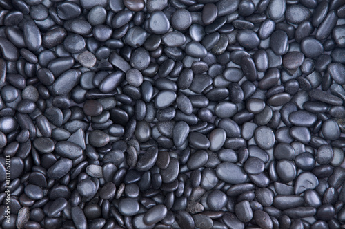 Background texture of waterworn black pebbles photo