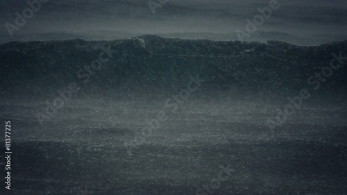 slow motion view of heavy rain dropping on the ocean waves
