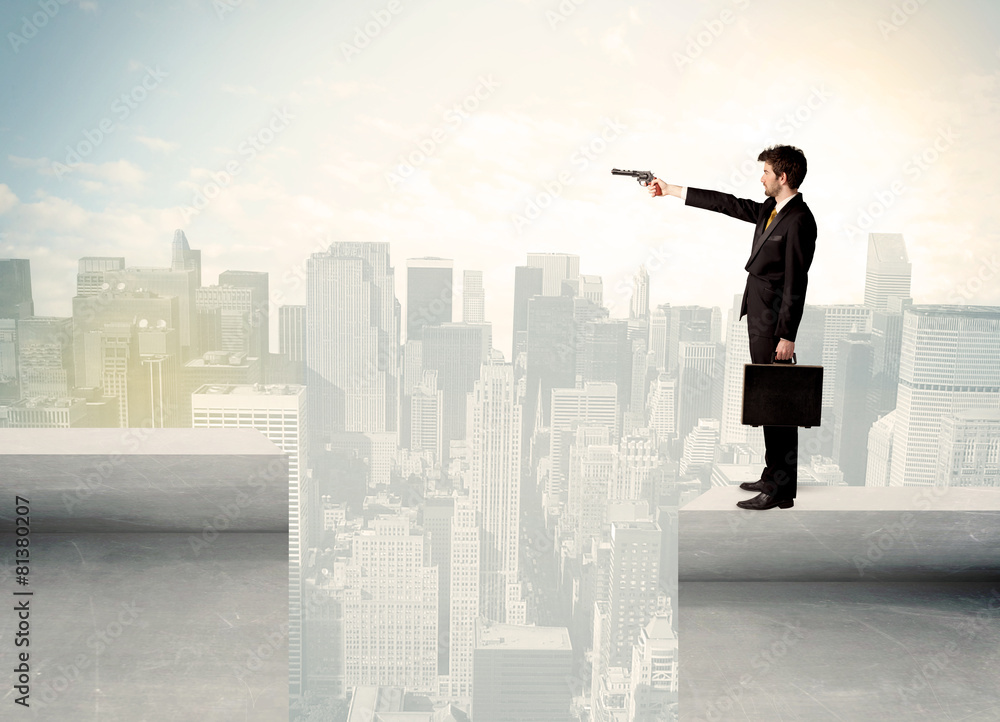 Businessman standing on the edge of rooftop Businessman standing on the edge of rooftop