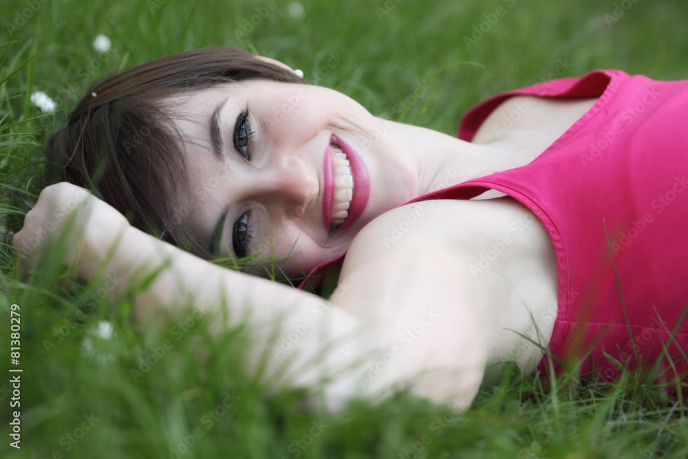 Smiling woman relaxing on the lawn Smiling woman relaxing on the lawn