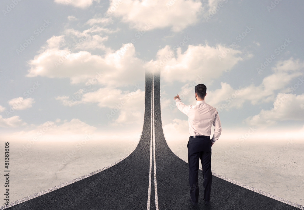 Obraz premium Businessman looking at 3d road that goes up in the sky
