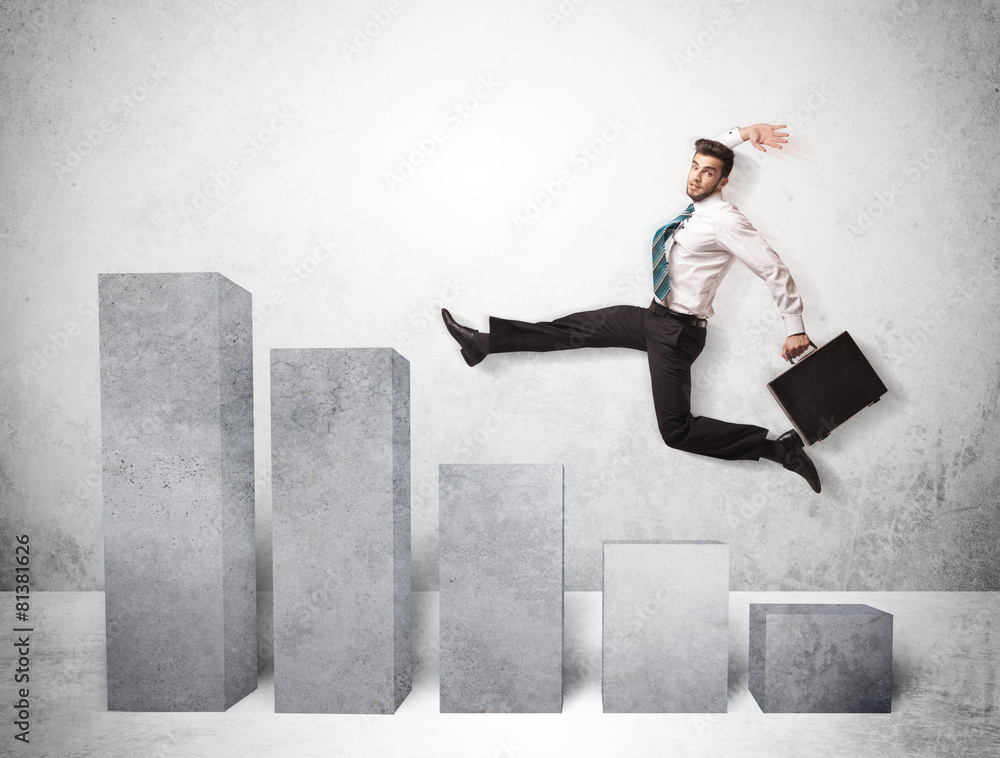 Successful business man jumping over charts on background Successful business man jumping over charts on background