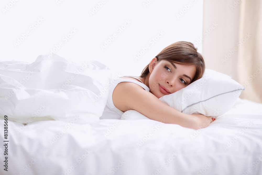 Beautiful girl sleeps in the bedroom, lying on bed Beautiful girl sleeps in the bedroom, lying on bed
