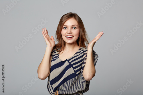Surprised young stylish slim female holding her head in amazemen photo