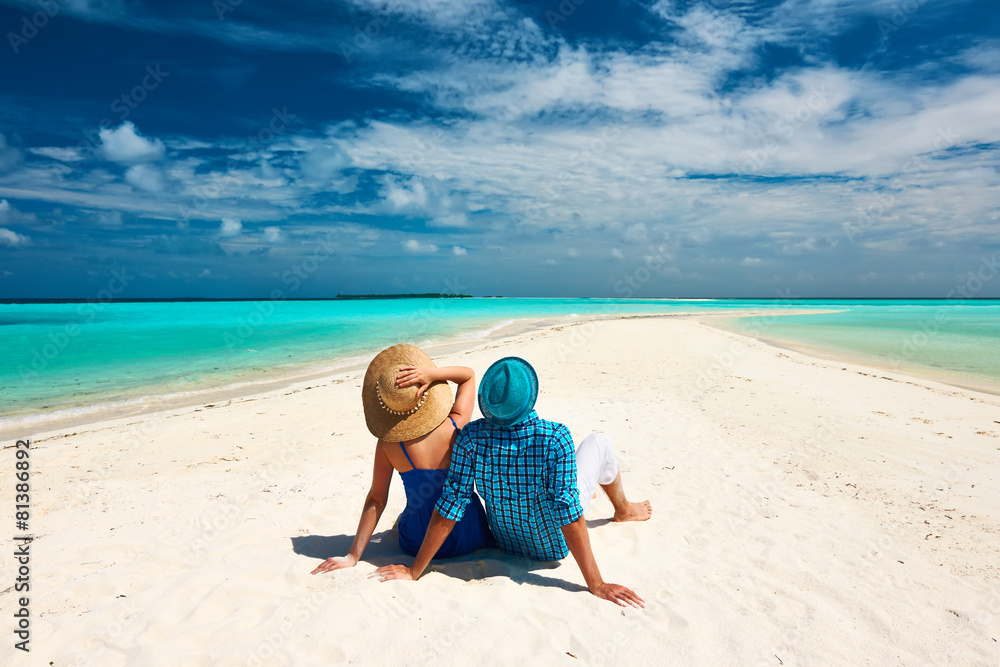 Couple in blue on a beach at Maldives Couple in blue on a beach at Maldives