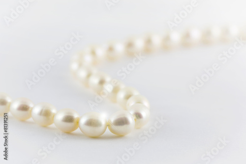 Beautiful creamy pearls necklace isolated on white background.